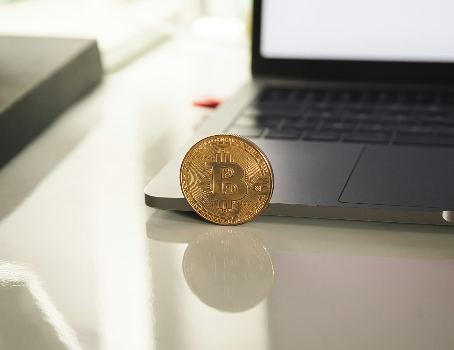 silver round coin on white table