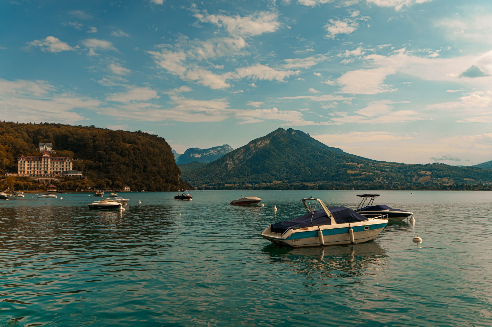 A group of boats floating on top of a lake